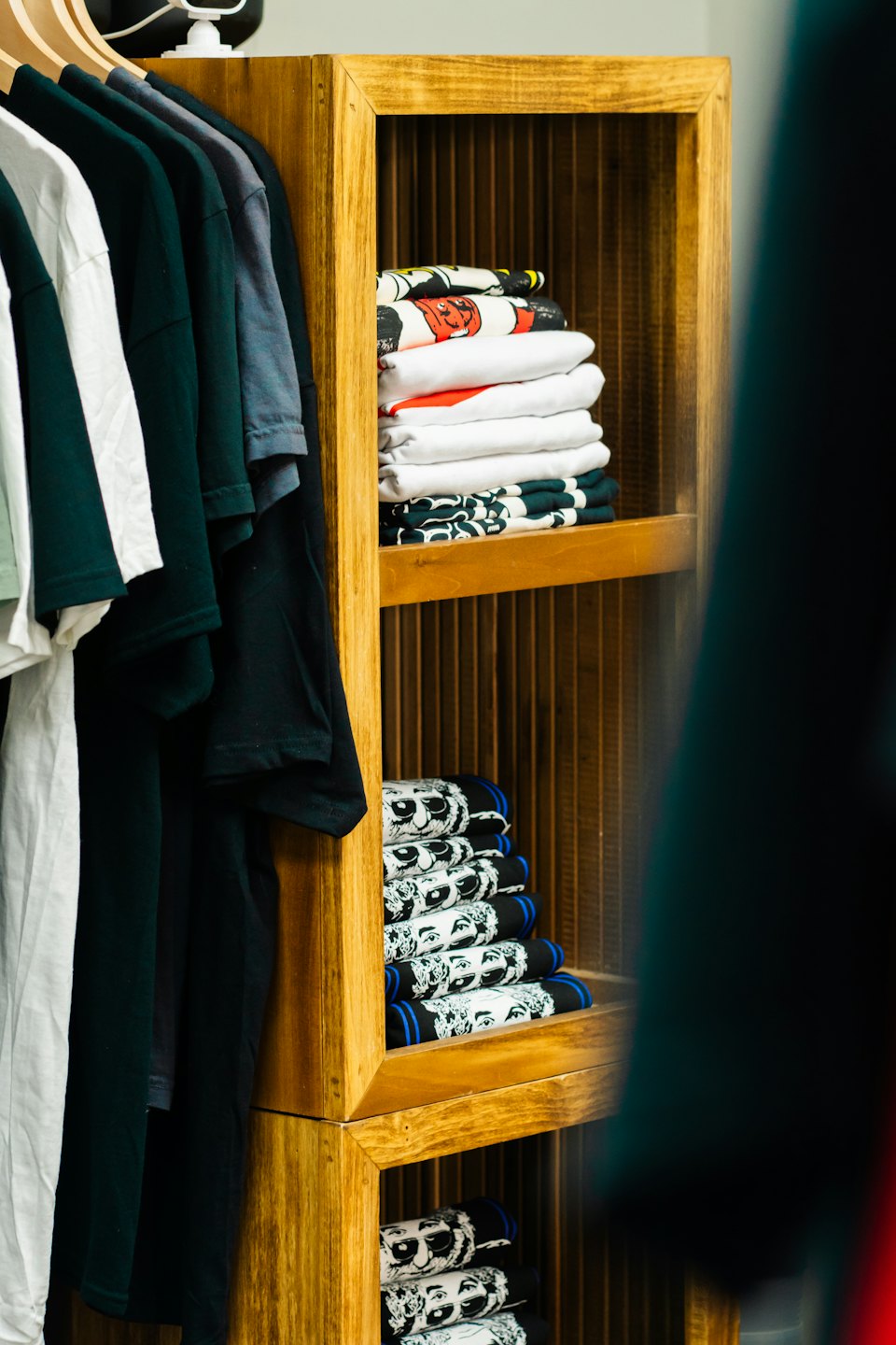 Clothing display with hanging and folded t-shirts.